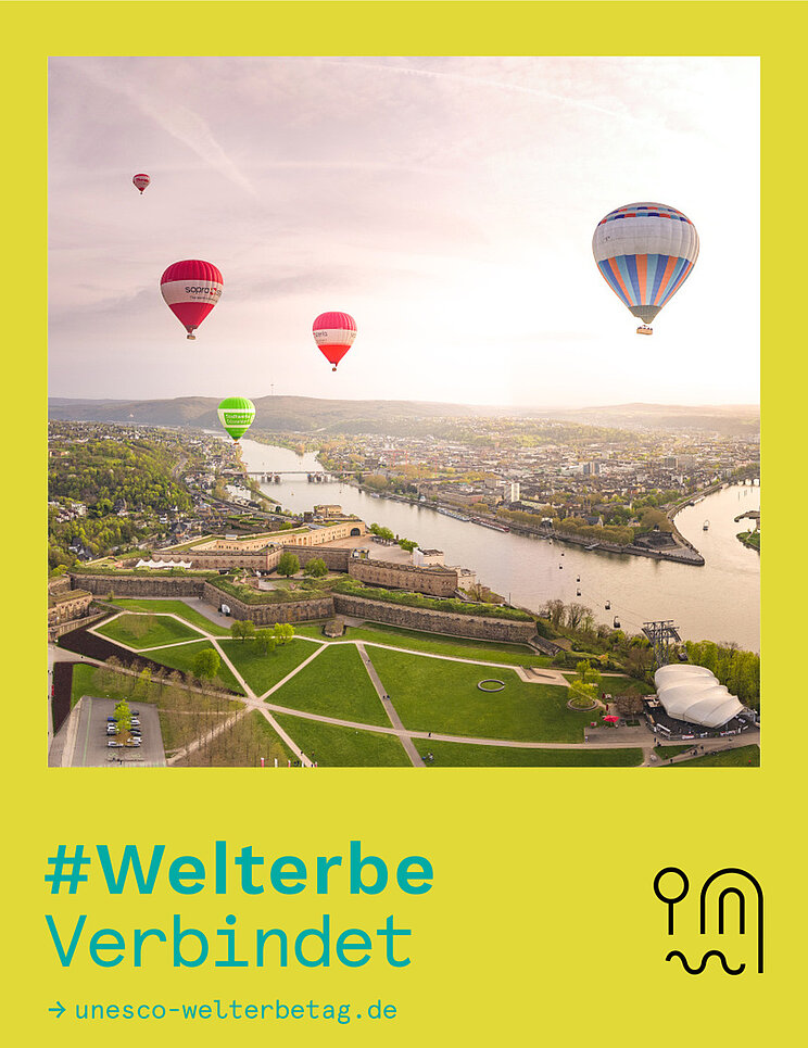 Fotowettbewerb #WelterbeVerbindet 2026 Platz 1 Blick auf Koblenz über die Festung Ehrenbreitstein mit aufsteigenden Heißluftballons