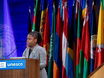 UNESCO_General_Conference_Flags Person speaks at UNESCO General Conference.