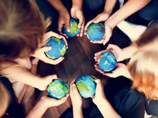 Kinder mit Weltkugeln in der Hand Kinder stehen im Kreis und halten je eine Weltkugel in der Hand.