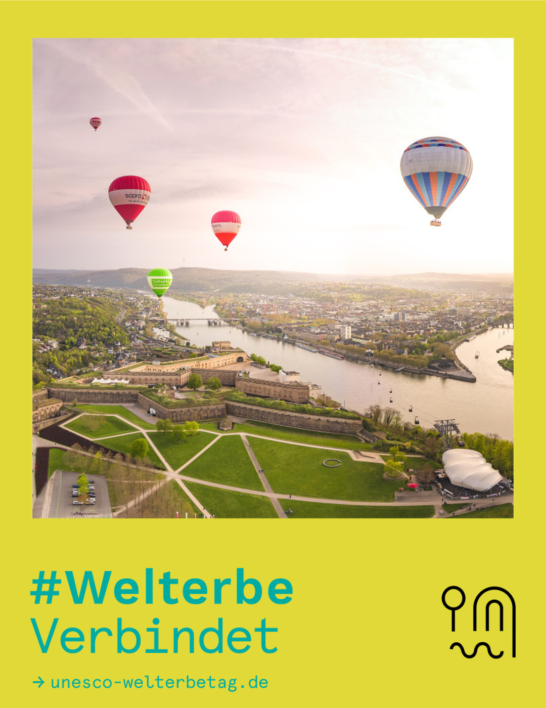 Fotowettbewerb #WelterbeVerbindet 2026 Platz 1 Blick auf Koblenz über die Festung Ehrenbreitstein mit aufsteigenden Heißluftballons